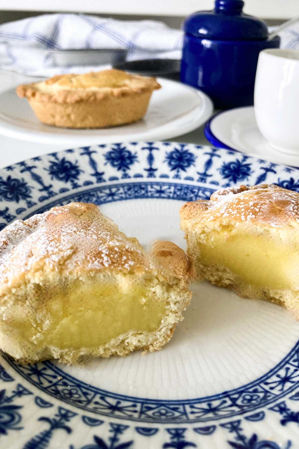 Homemade pasticciotto cut in half, showing the creamy Italian pastry cream filling