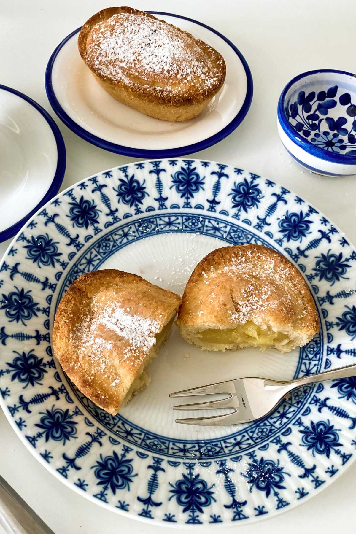 Pasticciotto leccese cut into pieces and served on a blue and white plate