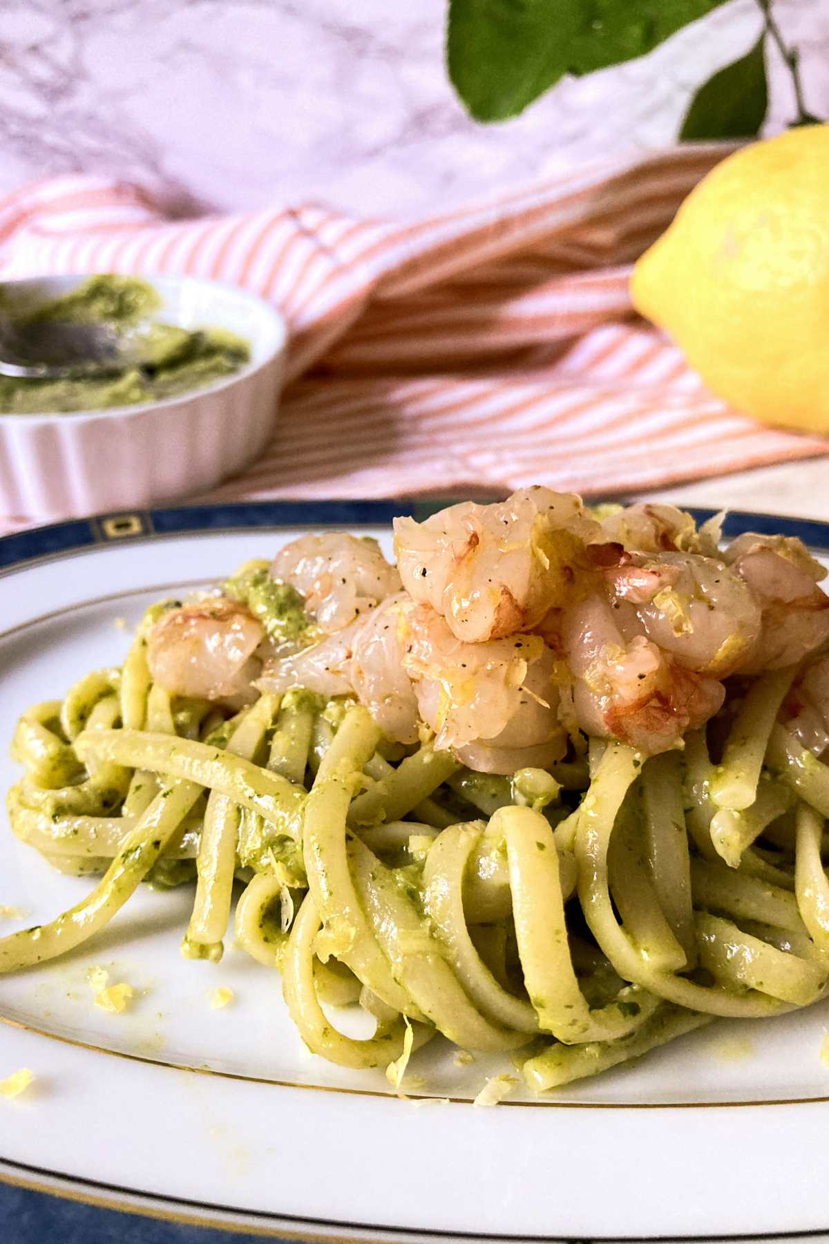 shrimp tartare pasta with pesto and lemon on plate close up