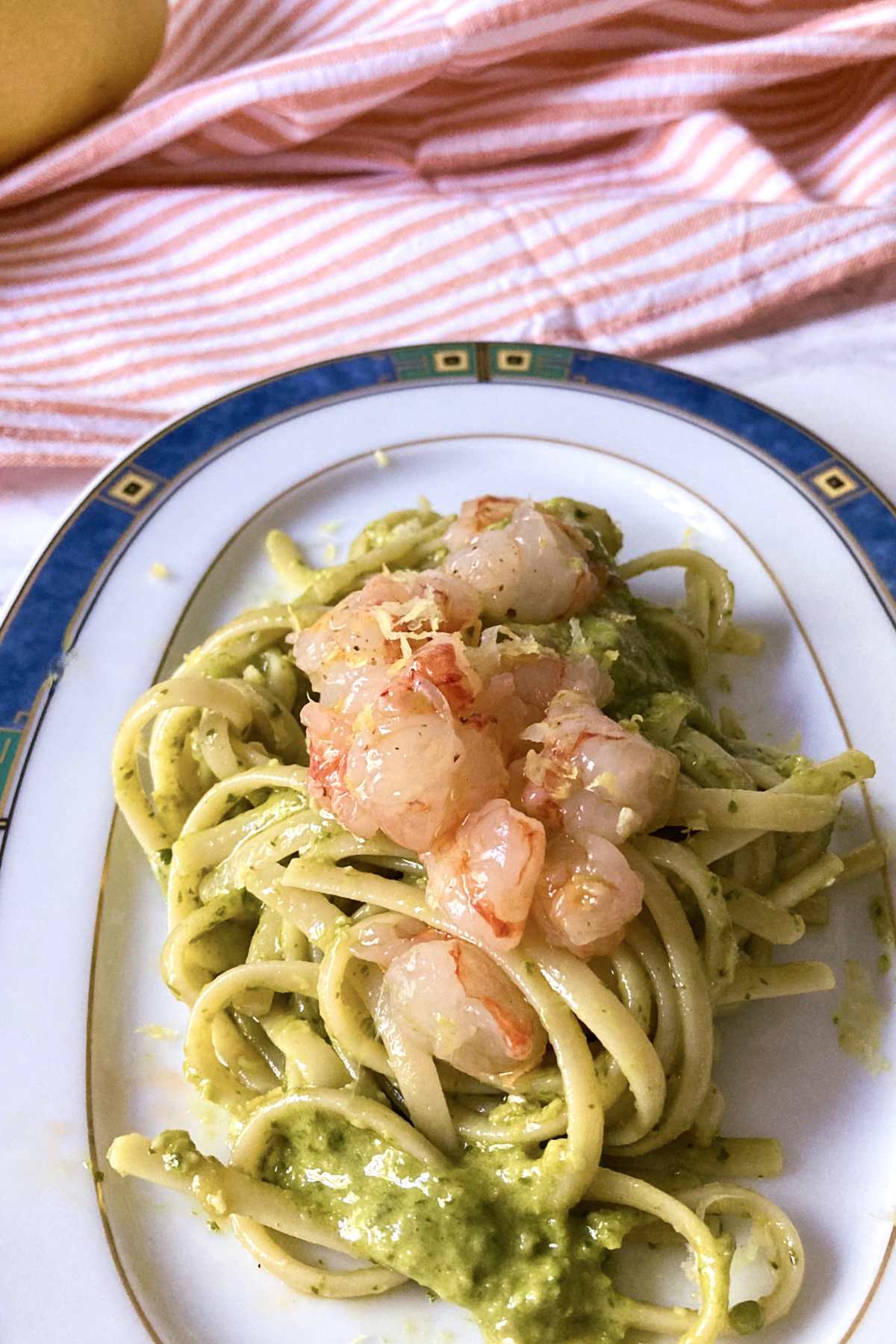top view of shrimp tartare pasta with pesto and lemon
