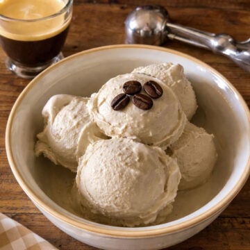 coffee gelato scoops in a bowl with espresso and coffee beans