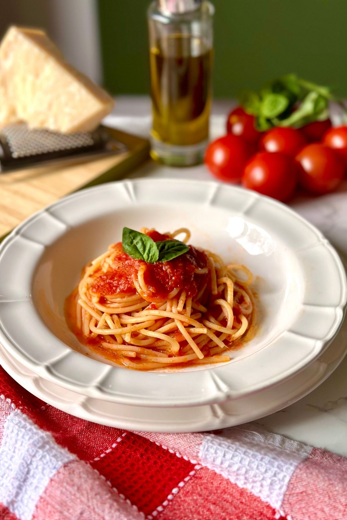 Spaghetti al Pomodoro served with basil, Parmigiano Reggiano and olive oil