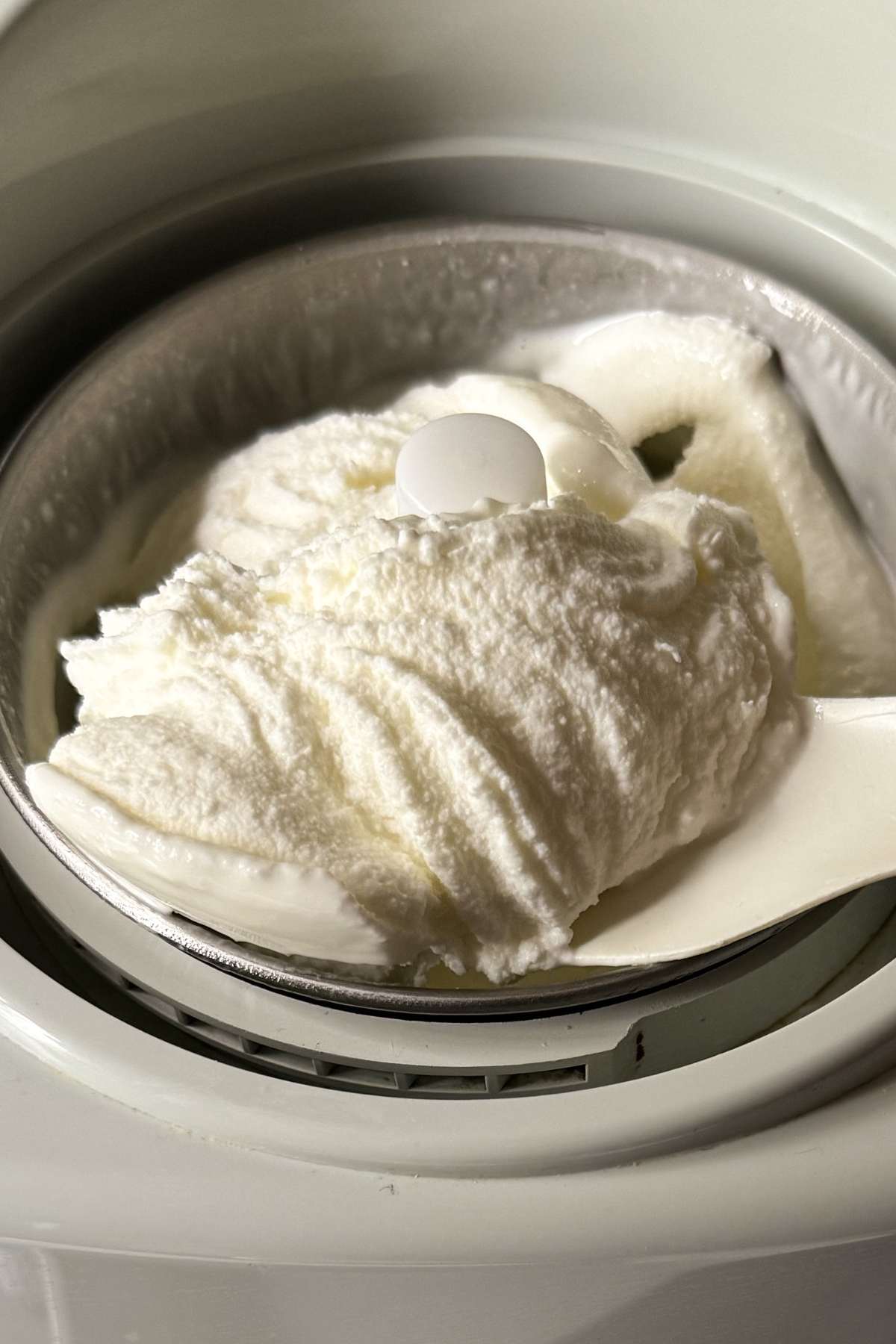 yogurt gelato churning in ice cream maker with creamy texture