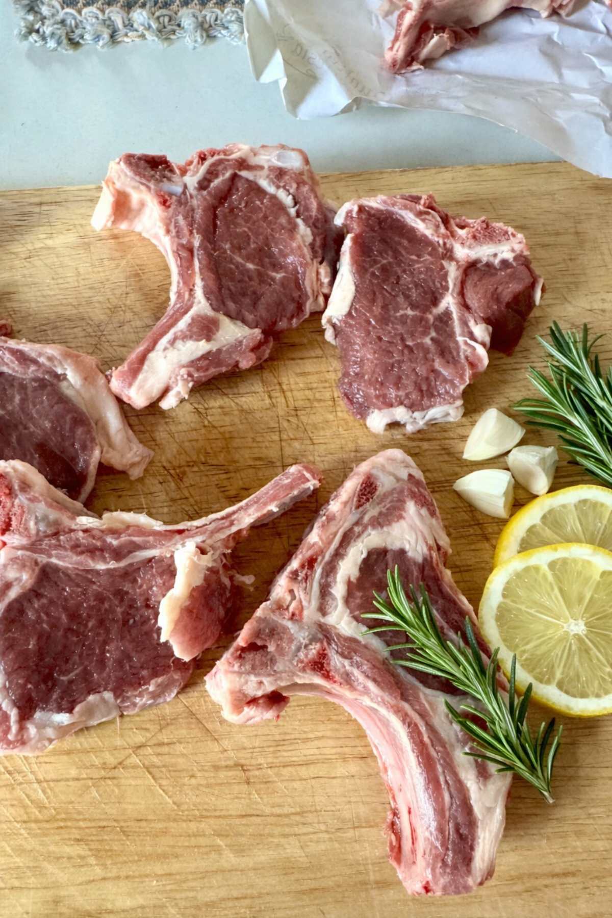 Raw lamb chops with rosemary, garlic and lemon for abbacchio a scottadito recipe