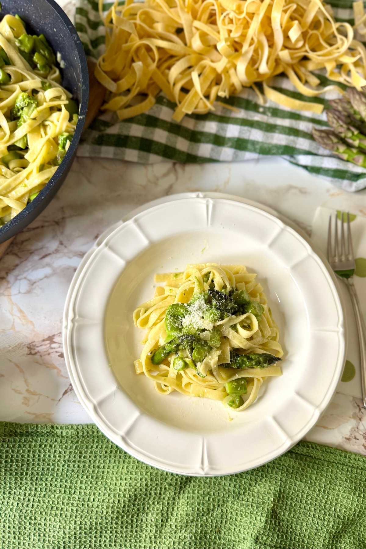 Italian tagliatelle with asparagus served on a plate with grated cheese