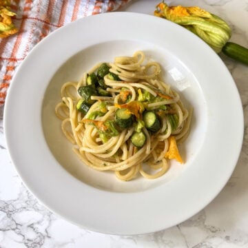 zucchini flower pasta with sliced zucchini and lemon zest