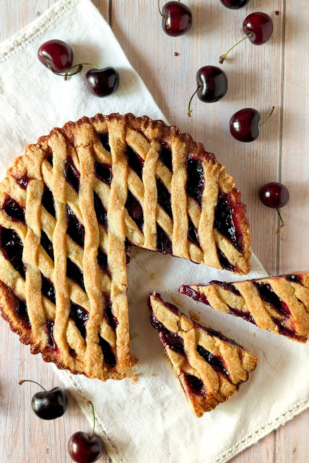 Fresh cherry crostata with sliced pieces and lattice crust